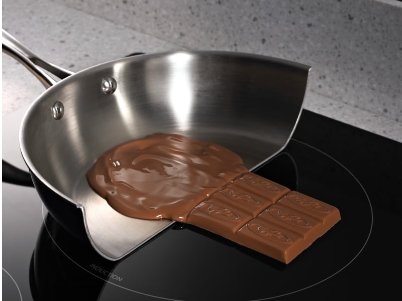 Melted chocolate in a pan on a glass cooktop Melted chocolate in a pan on a glass cooktop