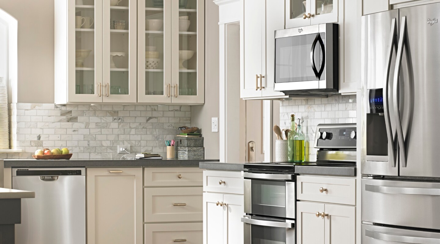 Bright, white kitchen with stainless steel appliances Bright, white kitchen with stainless steel appliances