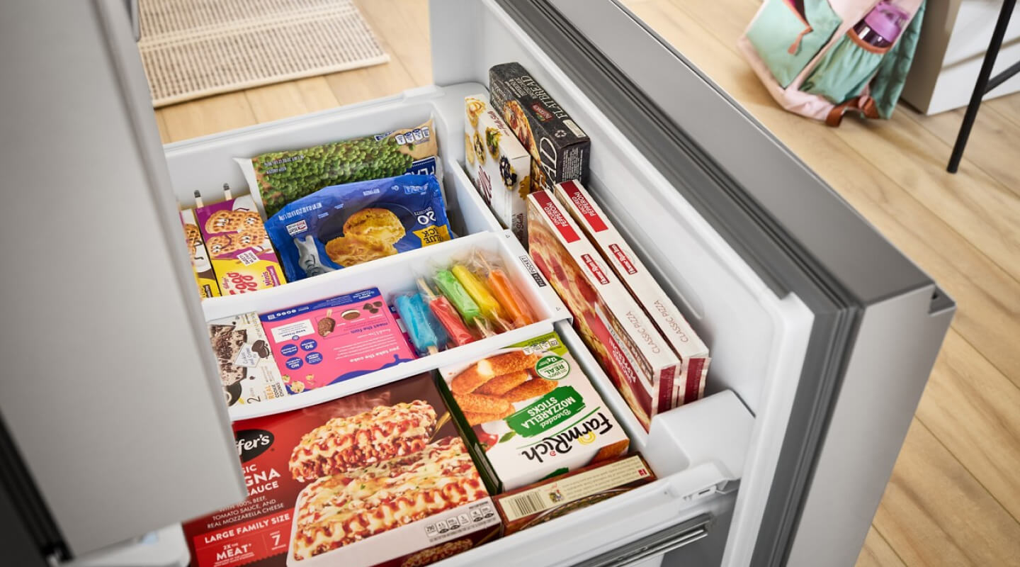 Open freezer drawer filled with food