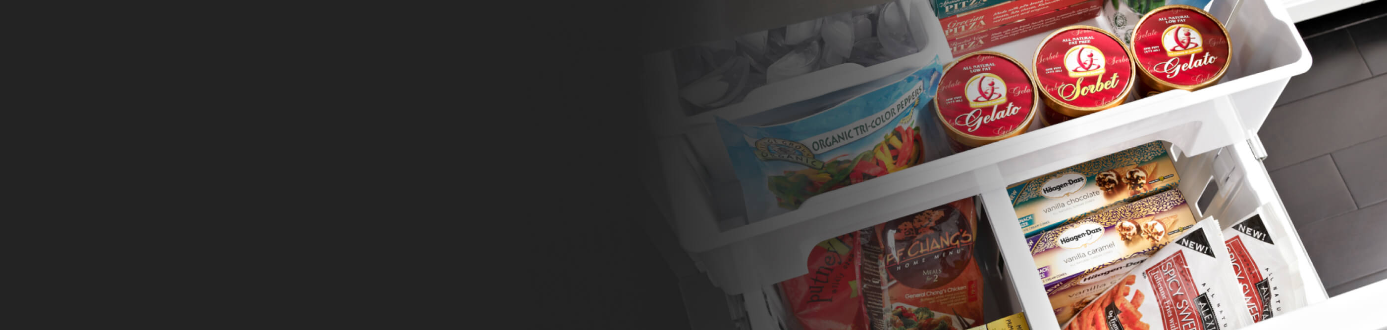 White freezer drawers opened showing a variety of frozen foods