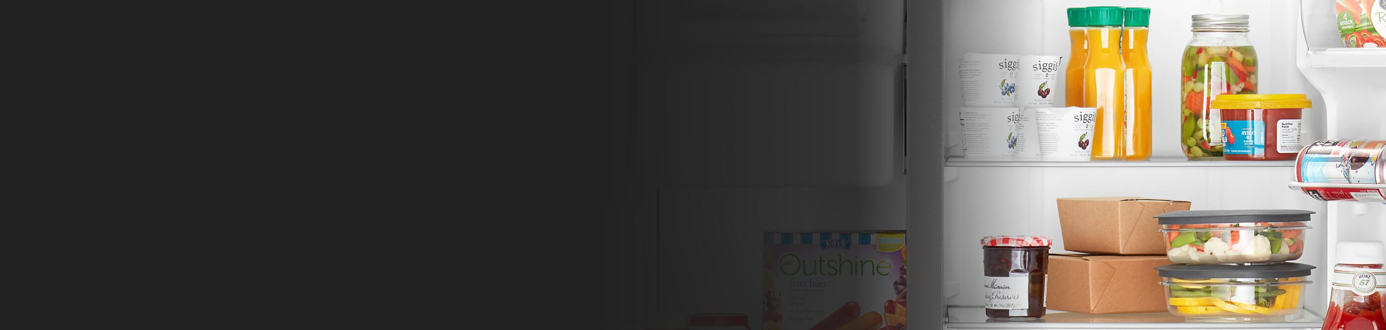 Various food items and beverages stored in a side-by-side refrigerator