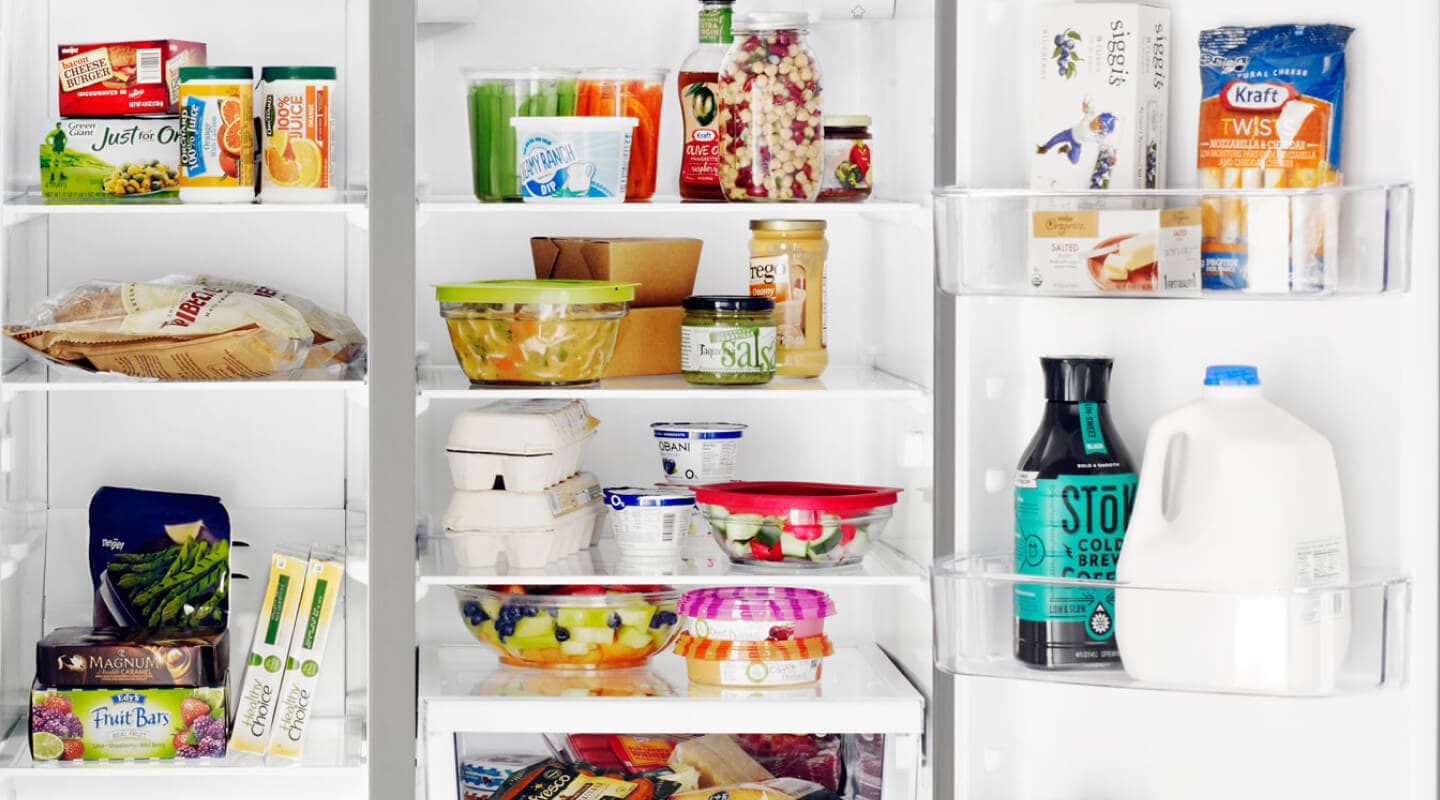 A closeup of the interior of a Whirlpool® side-by-side refrigerator with food and beverage items A closeup of the interior of a Whirlpool® side-by-side refrigerator with food and beverage items