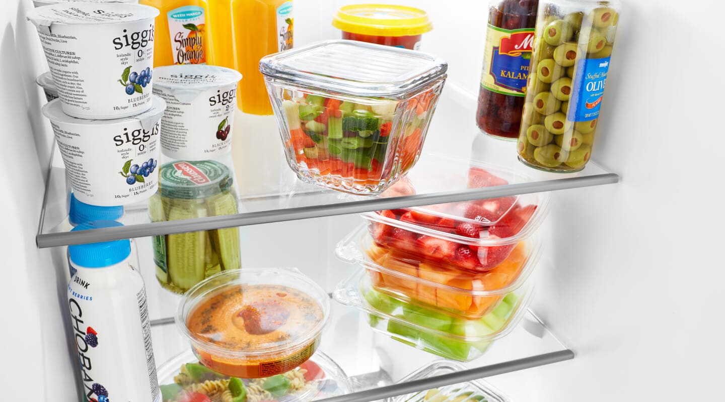 Food items and ingredients stored on a fridge shelf Food items and ingredients stored on a fridge shelf