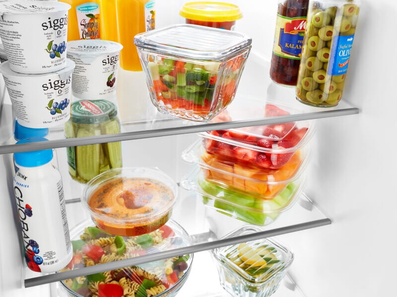 Food items and ingredients stored on a fridge shelf Food items and ingredients stored on a fridge shelf