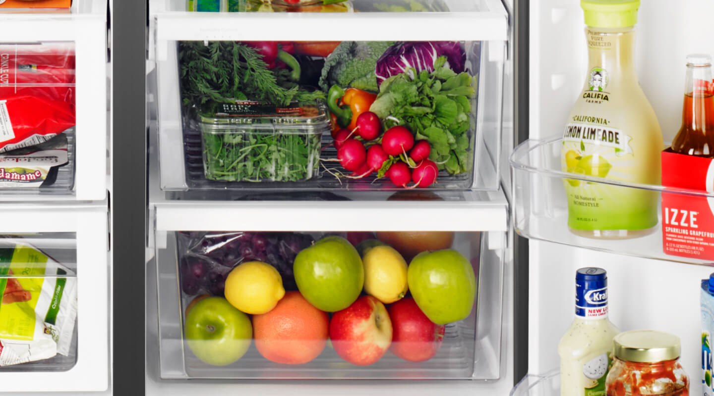Fresh fruits and vegetables stored in a fridge crisper drawer Fresh fruits and vegetables stored in a fridge crisper drawer