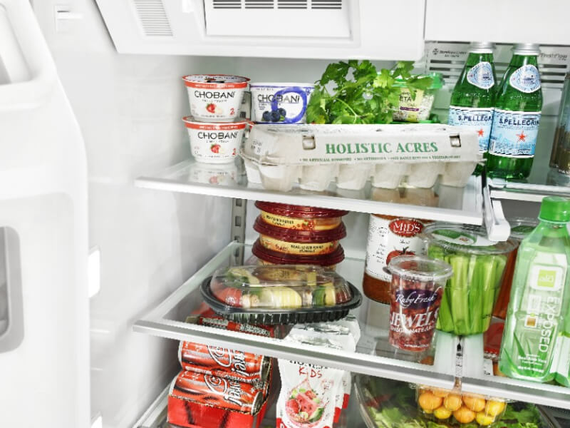 Open Whirlpool® Refrigerator filled with food Open Whirlpool® Refrigerator filled with food