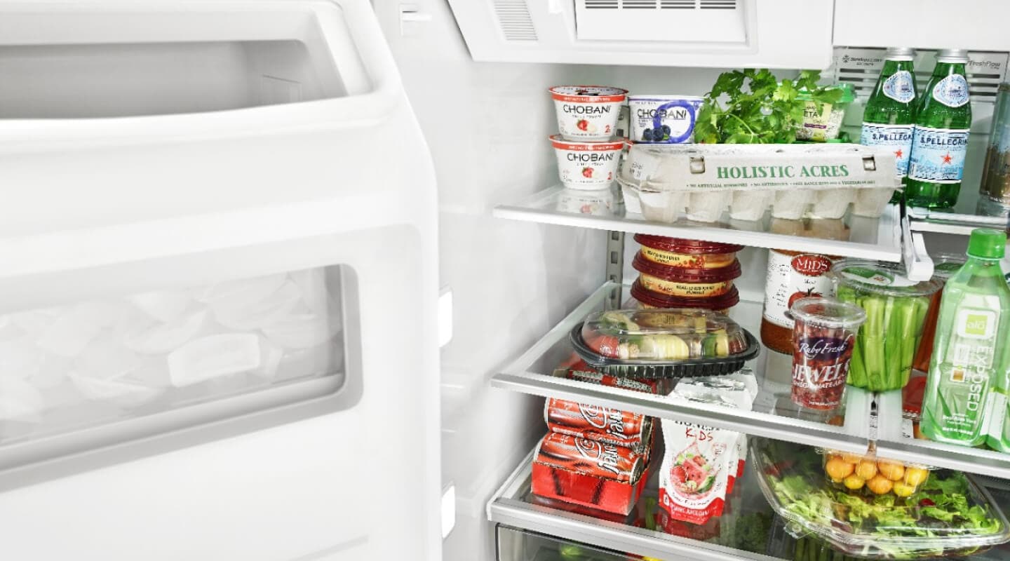 Open Whirlpool® Refrigerator filled with food Open Whirlpool® Refrigerator filled with food
