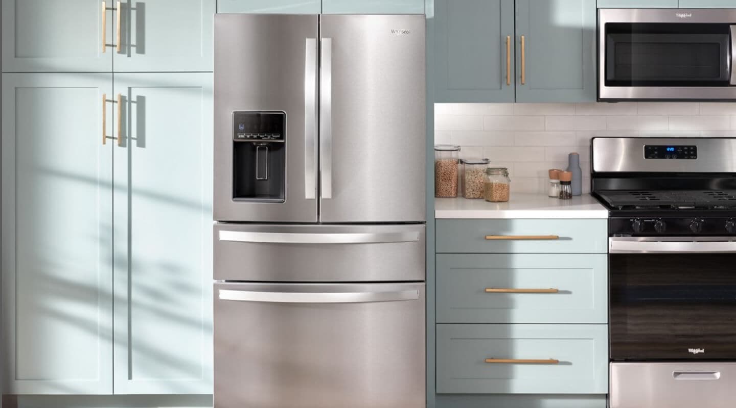 A kitchen with blue cabinets and Whirlpool® appliances A kitchen with blue cabinets and Whirlpool® appliances