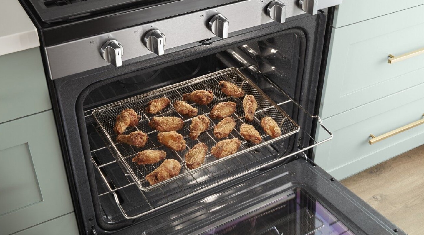 Fried chicken laid out on a cooking rack in the oven Fried chicken laid out on a cooking rack in the oven