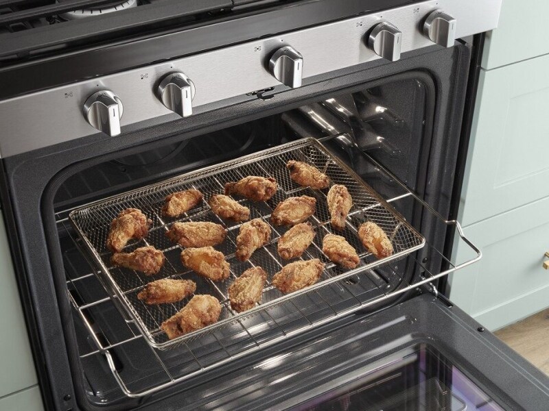 Fried chicken laid out on a cooking rack in the oven Fried chicken laid out on a cooking rack in the oven