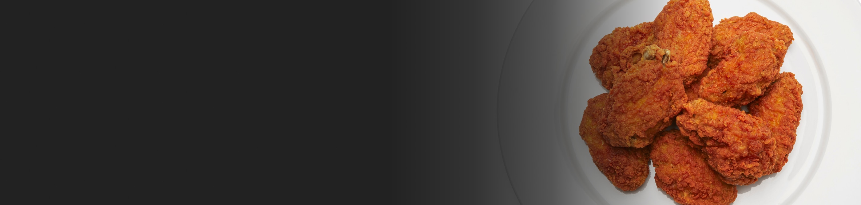 Several pieces of fried chicken on a plate