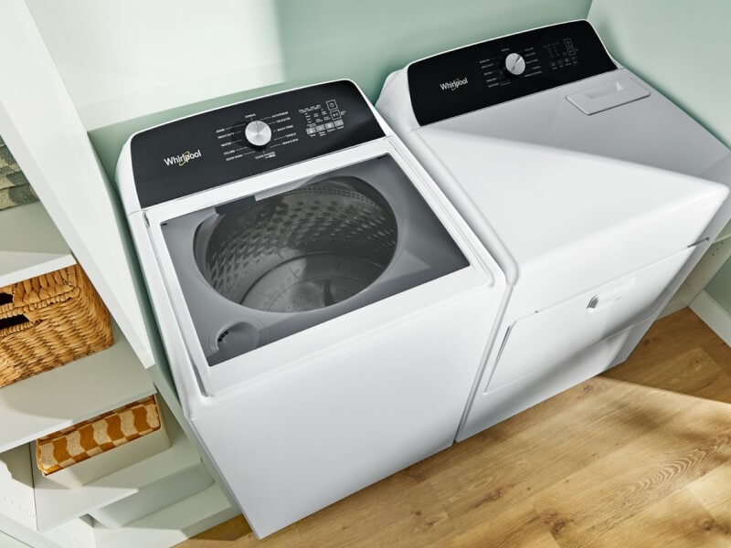 A laundry area with a Whirlpool® Top-Load Washer and Dryer A laundry area with a Whirlpool® Top-Load Washer and Dryer