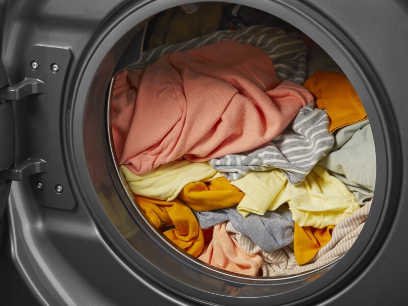 A washer filled with clothes A washer filled with clothes