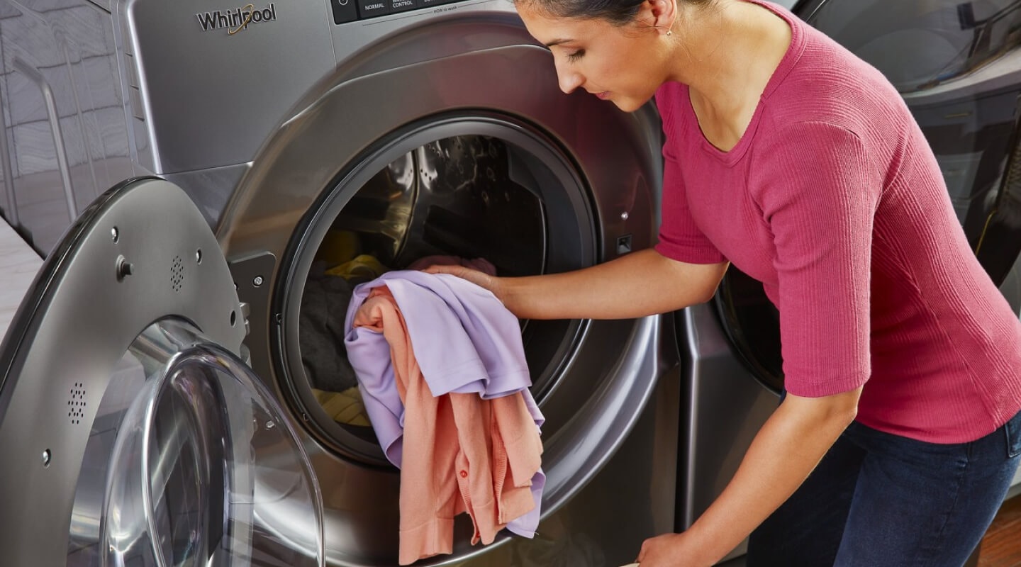 A person loading a washer A person loading a washer
