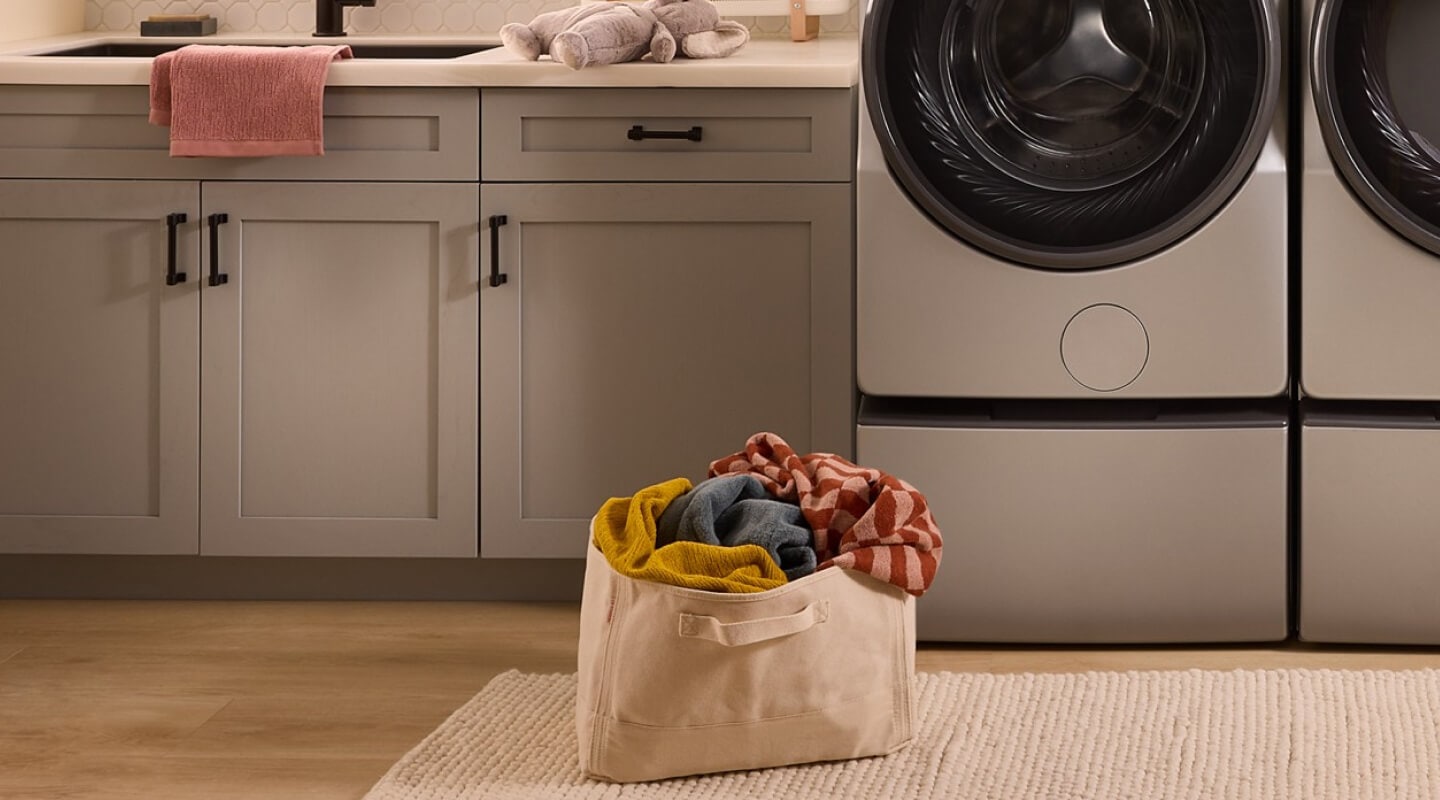 A bag of laundry on the floor of a laundry area A bag of laundry on the floor of a laundry area