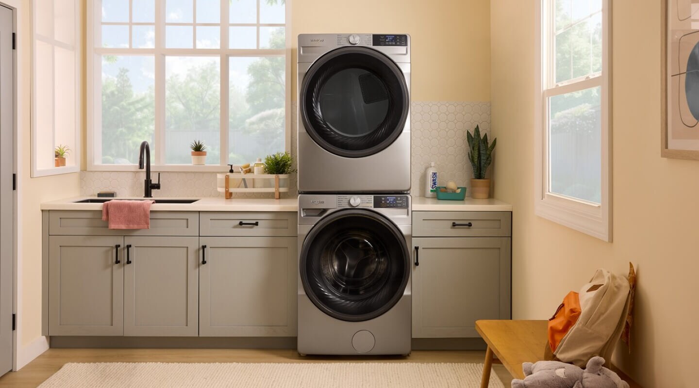 A laundry area with a stackable smart front load washer and dryer by Whirlpool brand