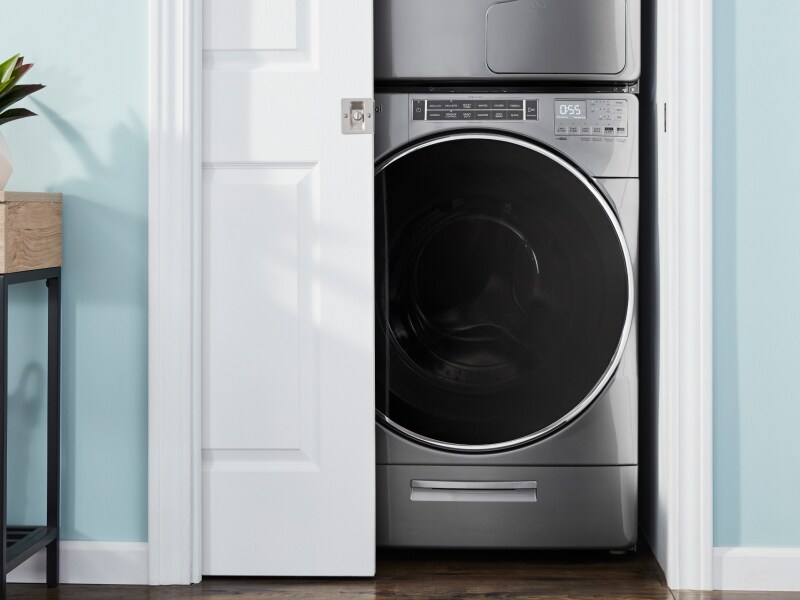 A front load washer in an open closet A front load washer in an open closet
