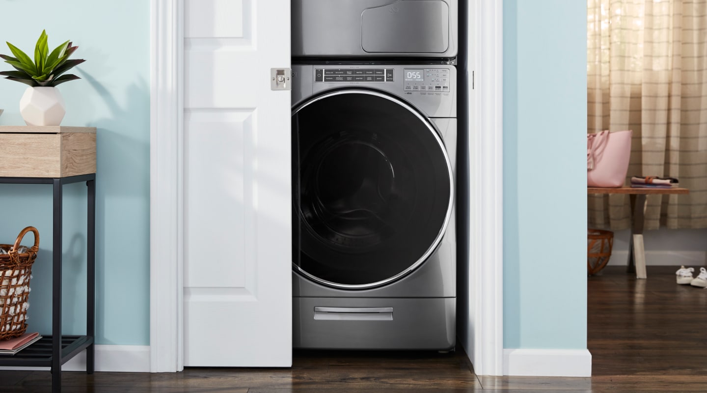 A front load washer in an open closet A front load washer in an open closet