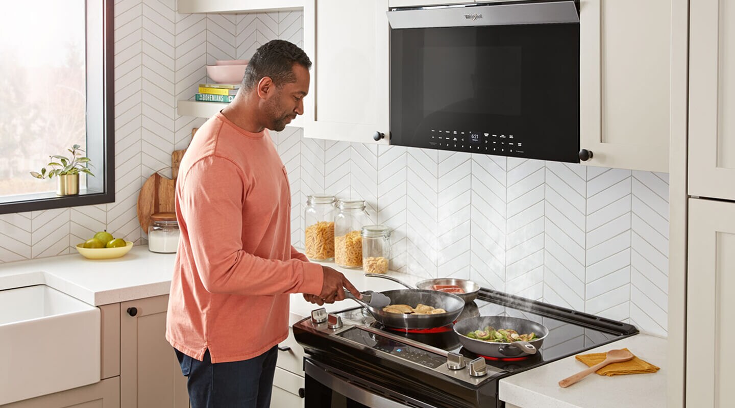 Person cooking on an electric range Person cooking on an electric range