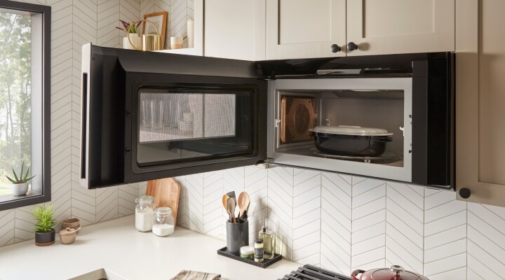 Food in an over-the-range microwave with the door open Food in an over-the-range microwave with the door open