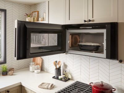 Food in an over-the-range microwave with the door open Food in an over-the-range microwave with the door open