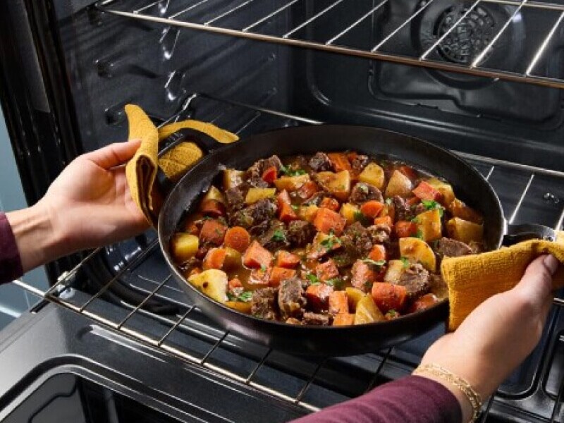 Pot of stew coming out of an oven