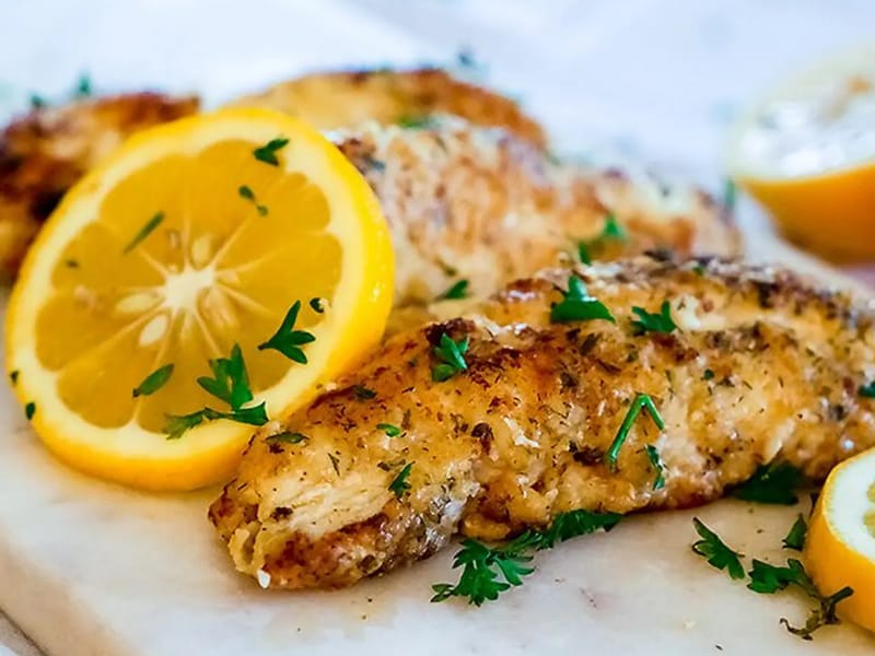 Seasoned fish with lemon slices Seasoned fish with lemon slices