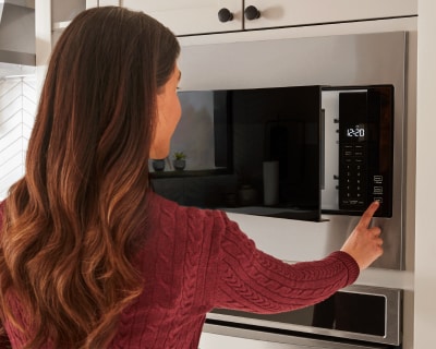 Person making a selection on the microwave