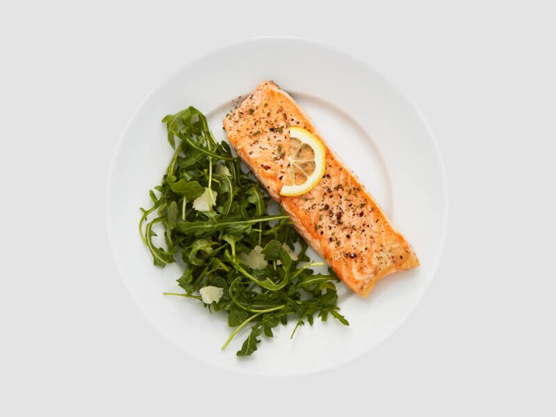 Fish and vegetables on a white plate Fish and vegetables on a white plate