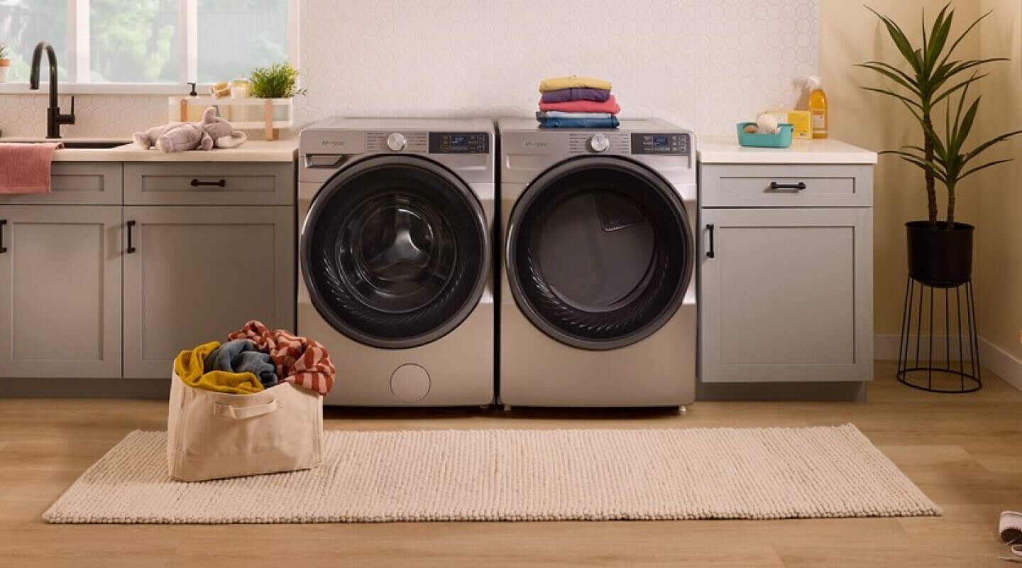 Radiant Silver Whirlpool® Front Load Washer and Dryer set in a laundry room