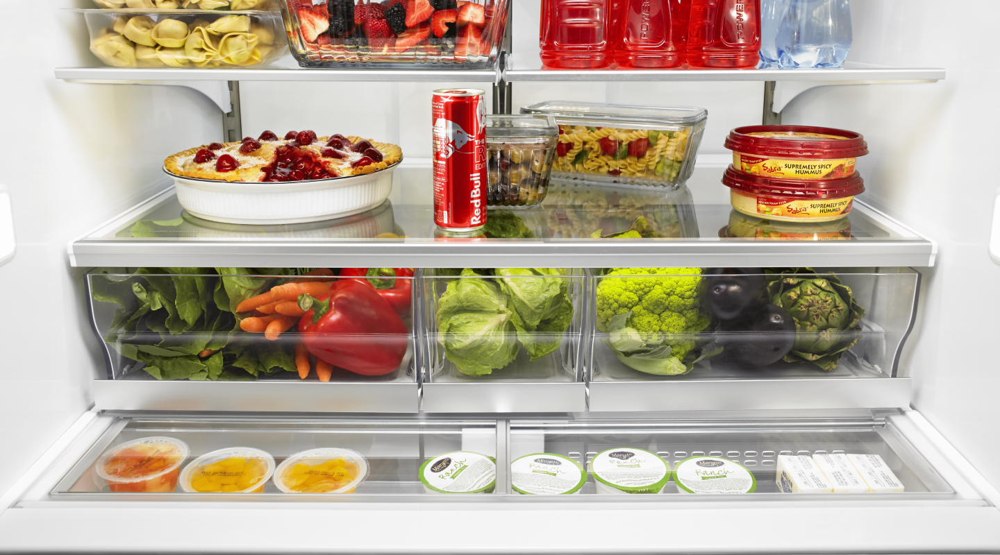 Open refrigerator full of produce, baked goods and beverages Open refrigerator full of produce, baked goods and beverages