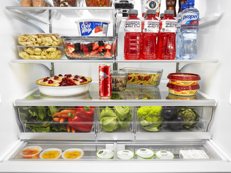 Open refrigerator full of produce, baked goods and beverages Open refrigerator full of produce, baked goods and beverages