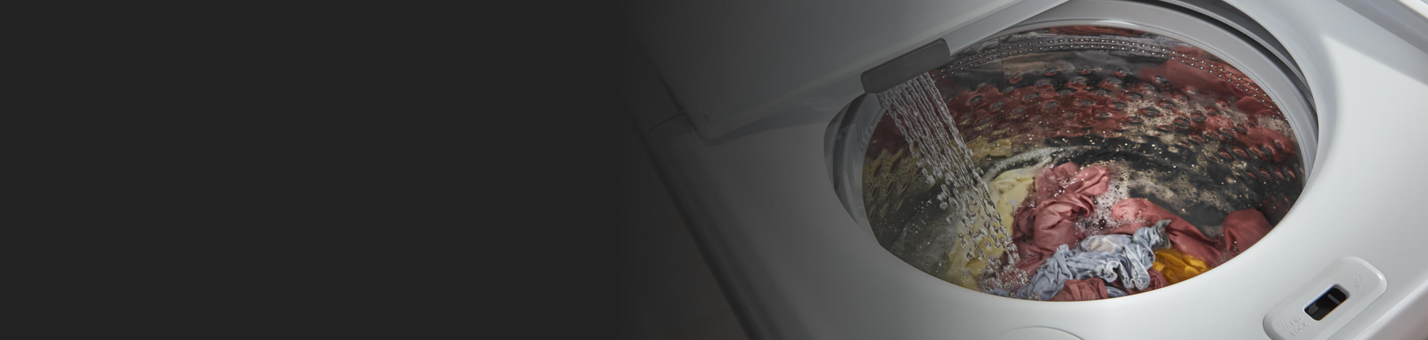 An open washer filling with water
