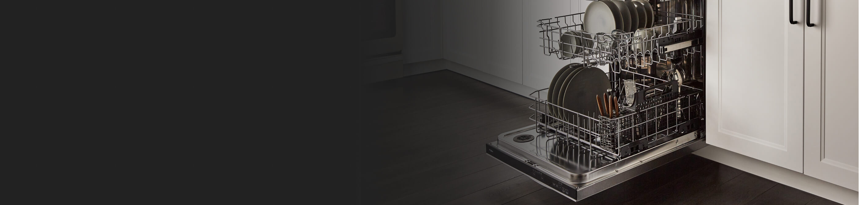 An open Whirlpool® dishwasher loaded with dishes