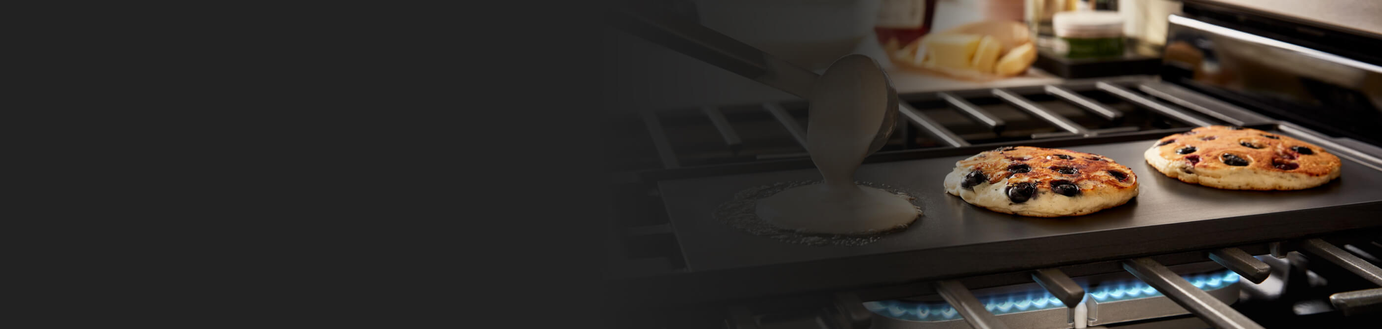 Pancakes cooking on a stovetop griddle