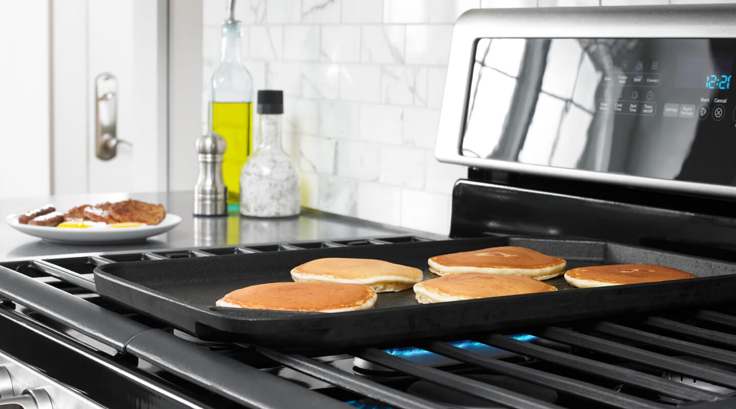 Pancakes cooking on a griddle Pancakes cooking on a griddle