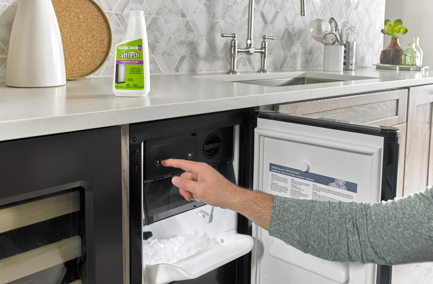 Person opening a built-in icemaker next to affresh® cleaner Person opening a built-in icemaker next to affresh® cleaner