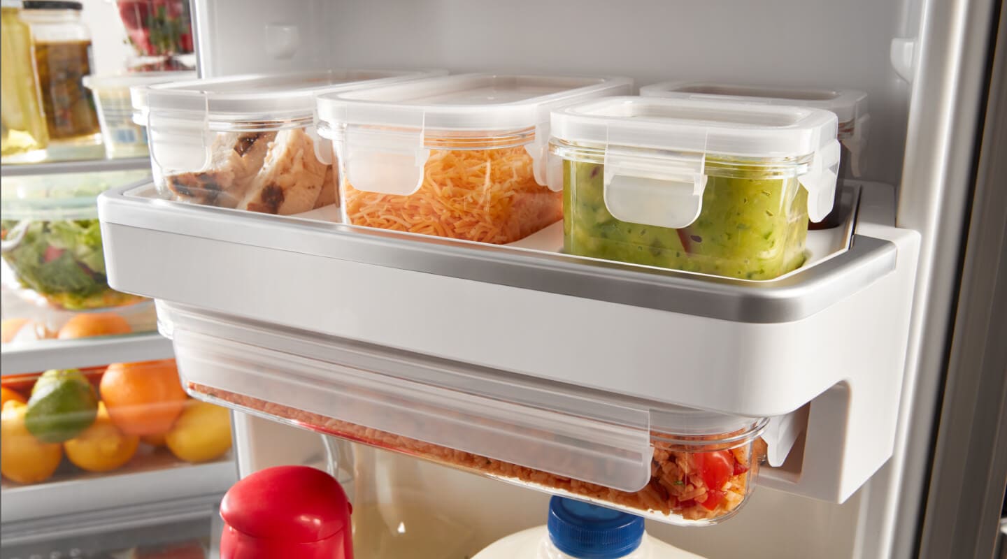 Food items in containers on a refrigerator shelf Food items in containers on a refrigerator shelf