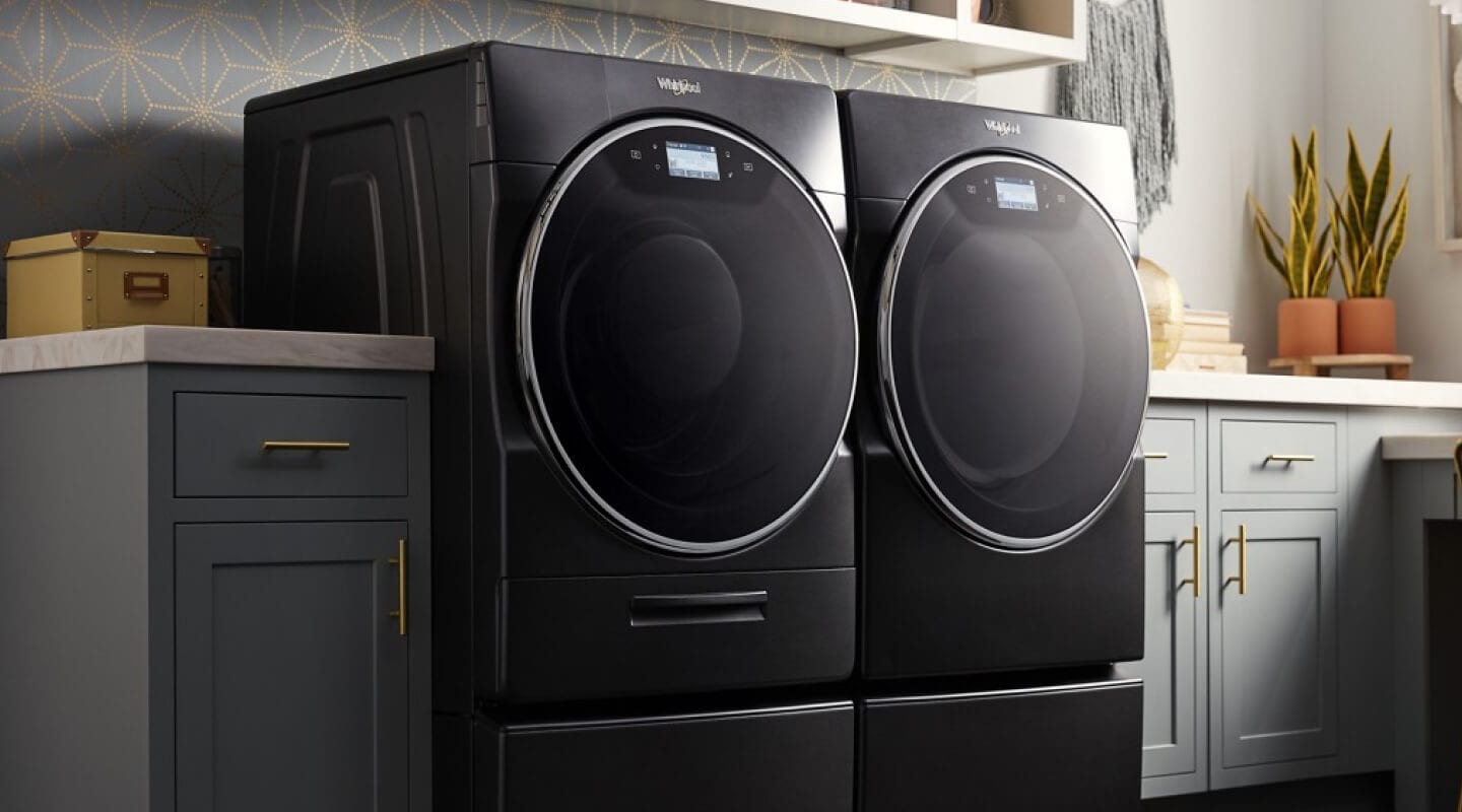 Whirlpool® front load washer and dryer in a modern laundry room