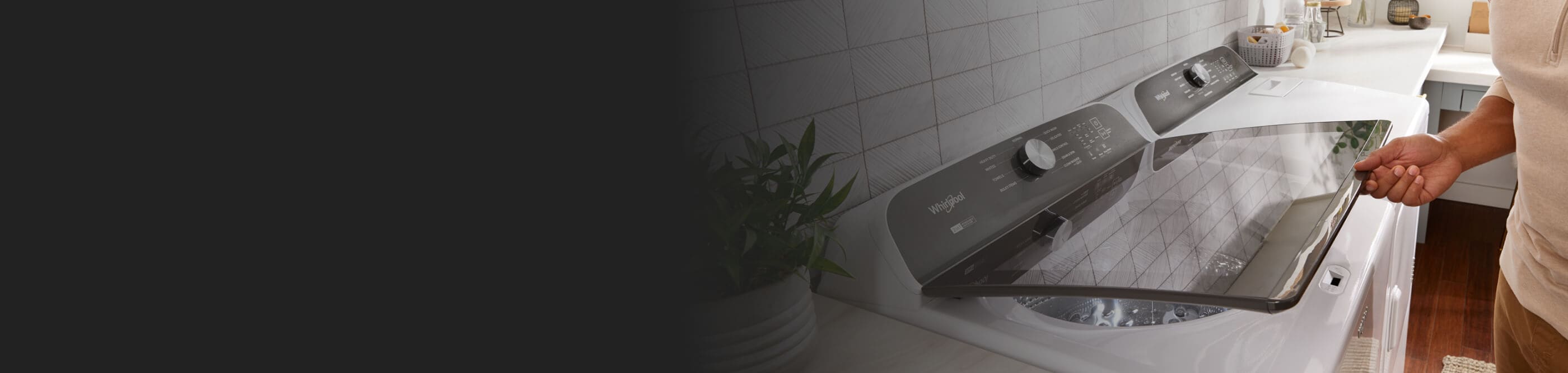 Person lifting the glass lid on a Whirlpool® Top Load Washer