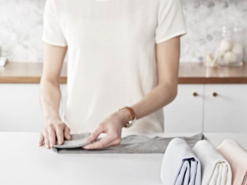 Person folding laundry Person folding laundry