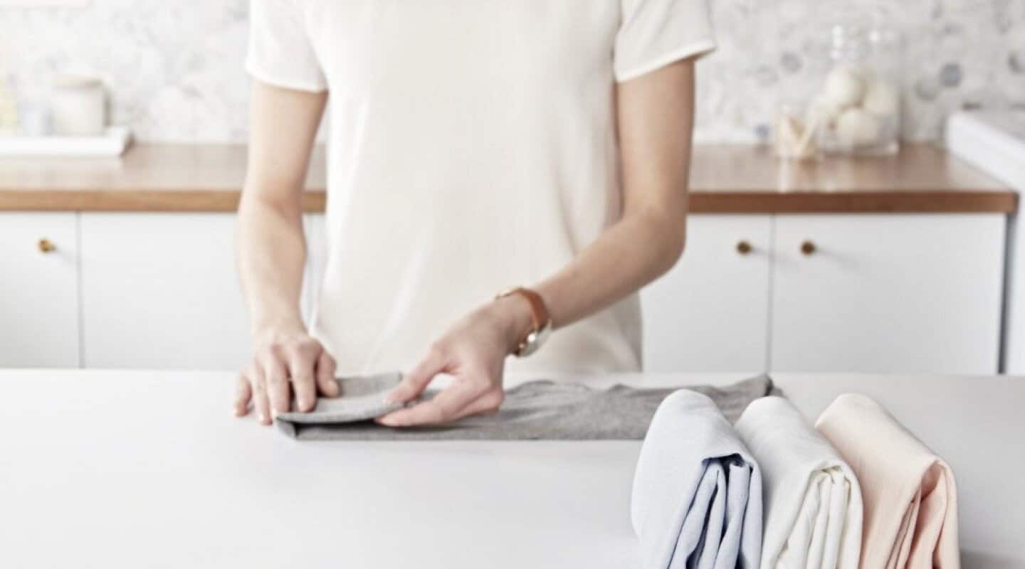 Person folding laundry Person folding laundry