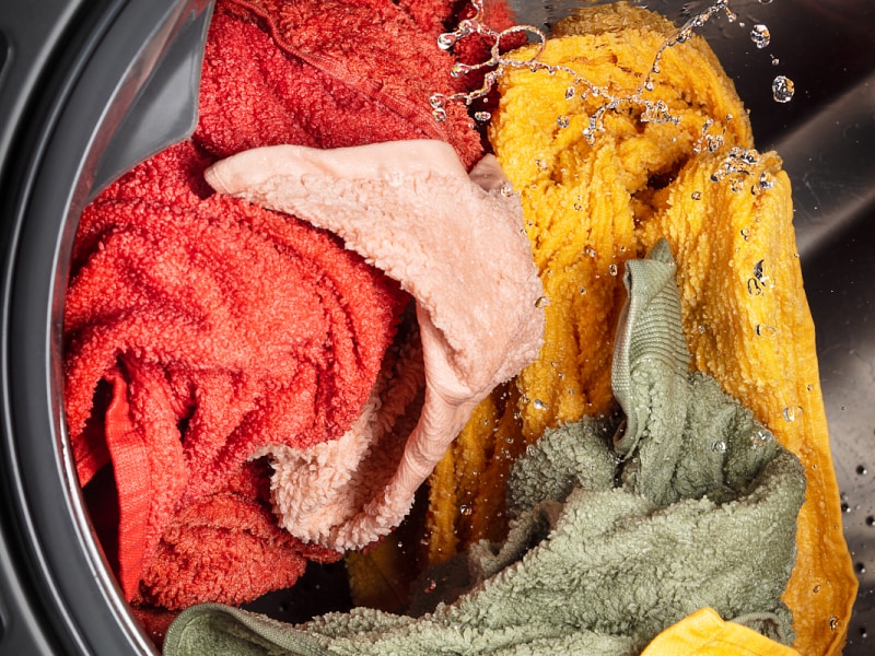 A closeup of laundry in a Whirlpool® washing machine. A closeup of laundry in a Whirlpool® washing machine.