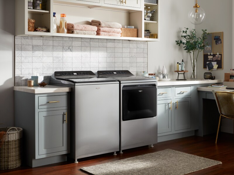 Whirlpool® top load washing machine and dryer in a rustic laundry room Whirlpool® top load washing machine and dryer in a rustic laundry room