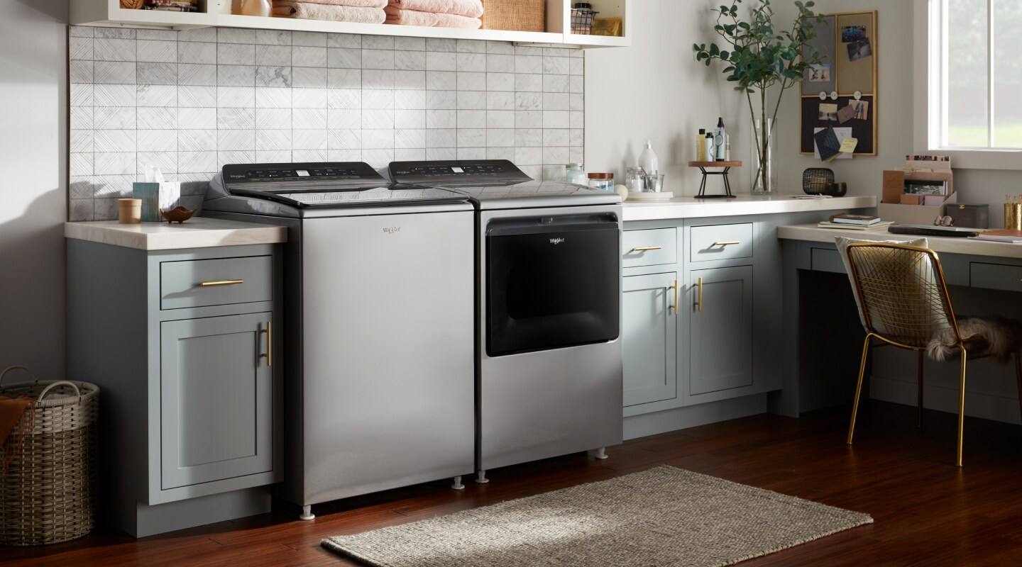 Whirlpool® top load washing machine and dryer in a rustic laundry room Whirlpool® top load washing machine and dryer in a rustic laundry room