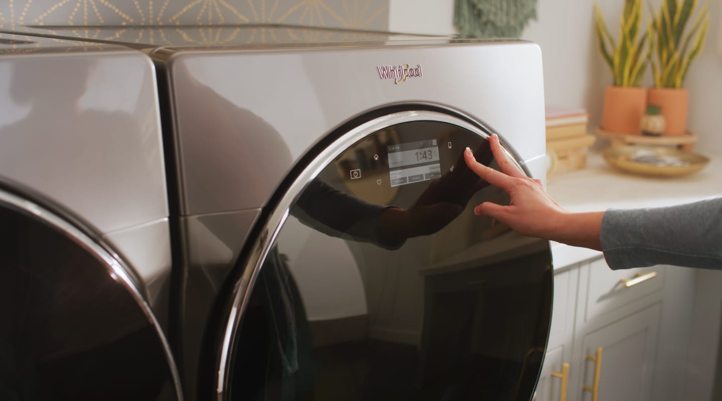 Person selecting a cycle on a Whirlpool® dryer Person selecting a cycle on a Whirlpool® dryer