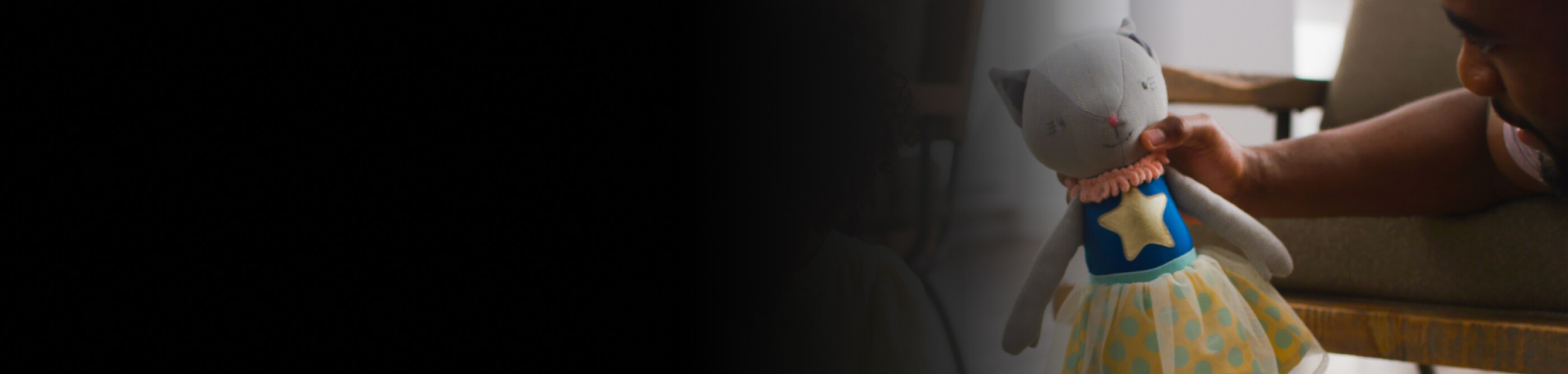 A person holding a stuffed animal