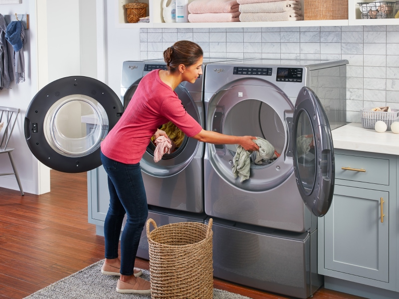 A woman loading laundry A woman loading laundry