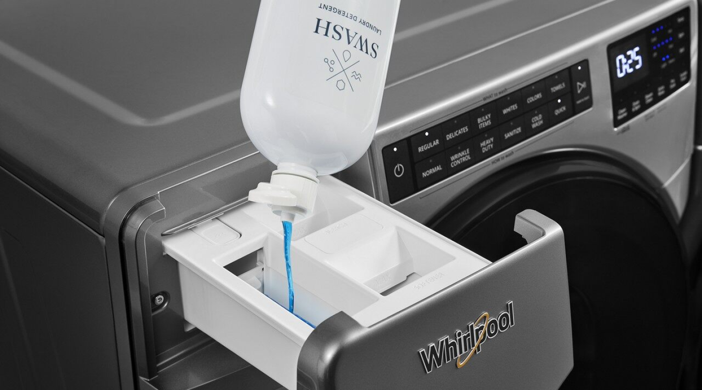 Swash detergent being poured into Whirlpool washer’s detergent dispenser. Swash detergent being poured into Whirlpool washer’s detergent dispenser.