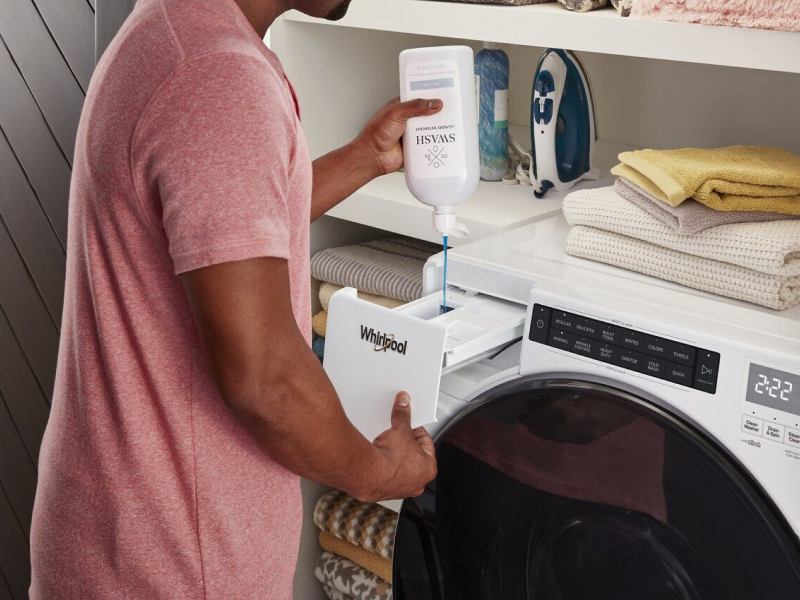 Pouring laundry detergent into the laundry dispenser